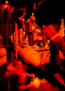 US Navy 030323-N-4048T-027 Deck Department personnel prepare to launch a Rigid Hull Inflatable Boat (RHIB) from aboard USS Kearsarge (LHD 3)