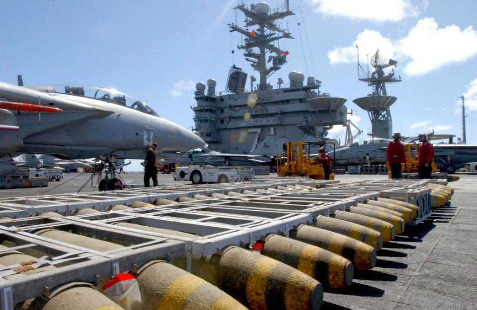 US Navy 030122-N-6895M-503 Aviation Ordnancemen transport bombs from the ship's flight deck