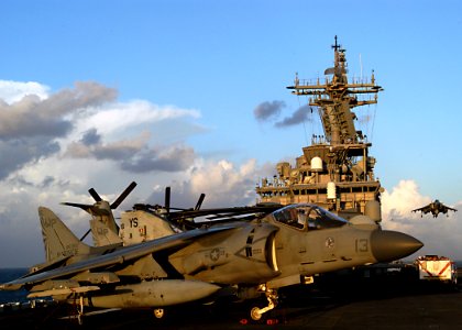 US Navy 030203-N-4048T-009 An AV-8B Harrier rests aboard Kearsarge as another (right) descends to land on the flight deck aboard the Wasp-class amphibious assault ship