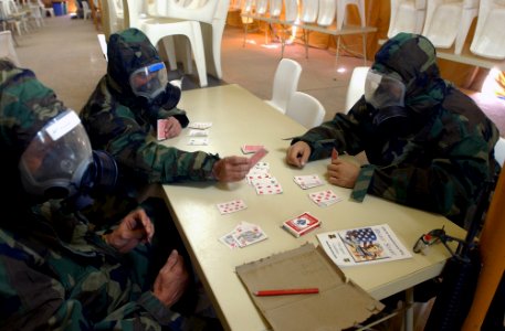 US Navy 030315-N-4309A-004 Navy Seabees are in a modified mission orientated protective posture (MOPP) level-3 while they play cards to pass the time during a recent Chemical, Biological, and Radiological (CBR) training exercis