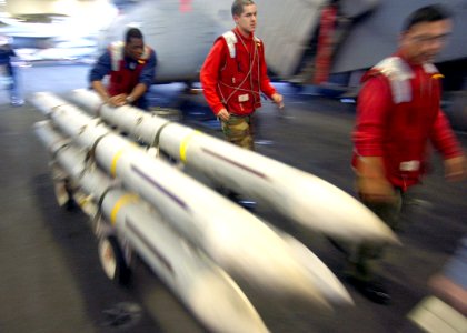 US Navy 030312-N-3235P-501 The Mediterranean Sea (Mar. 12, 2003) - Aviation Ordnancemen assigned to weapons department, transfer radar-guided AIM-7 Sparrow air-to-air missiles across the ship's hangar bay