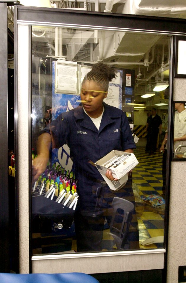 US Navy 030403-N-2143T-003 Ship's Serviceman Seaman Brown stocks a vending machine aboard USS Nimitz (CVN 68)