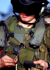US Navy 030206-N-4048T-077 A U.S. Marine Crew Chief loads ammunition into the magazine of an M-16 rifle