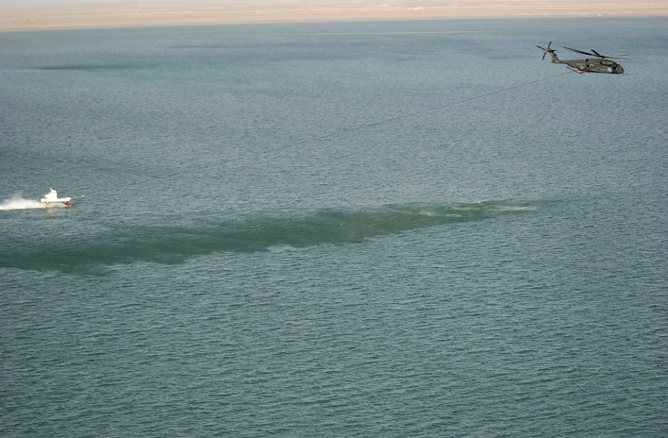 US Navy 030323-N-5319A-001 An MH-53 Sea Dragon helicopter from the 'Vanguards' of Helicopter Mine Countermeasures Squadron Fourteen (HM-14) pulls a Mark-105 magnetic sled during mine countermeasure operations