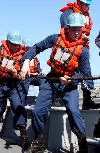 US Navy 030327-N-6141B-015 Deck Department personnel from the Arleigh Burke-class destroyer USS Donald Cook (DDG 75) receive stores during an underway replenishment (UNREP)