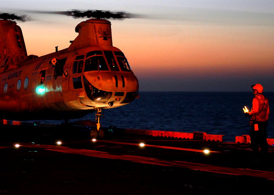 US Navy 030210-N-1512S-023 A CH-46 Sea Knight prepares to take-off from the ship's flight deck during evening flight quarters aboard USS Kearsarge (LHD 3)