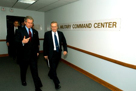 US Navy 030325-D-9880W-019 President George W. Bush and Secretary of Defense Donald H. Rumsfeld walk from the Pentagon's National Military Command Center where they received operational briefings