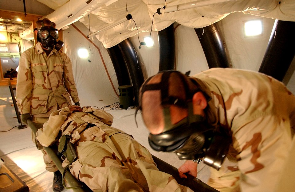 US Navy 030217-F-8362B-016 U.S. Navy Hospital Corpsmen 2nd Class Johnathan Bradford and Thomas Miller receive U.S. Navy Hospital Corpsman 3rd Class Sarah Cade through the Tunnel Air-Lock Litter Patient (TALP) door of a Chemical