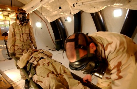 US Navy 030217-F-8362B-016 U.S. Navy Hospital Corpsmen 2nd Class Johnathan Bradford and Thomas Miller receive U.S. Navy Hospital Corpsman 3rd Class Sarah Cade through the Tunnel Air-Lock Litter Patient (TALP) door of a Chemical photo