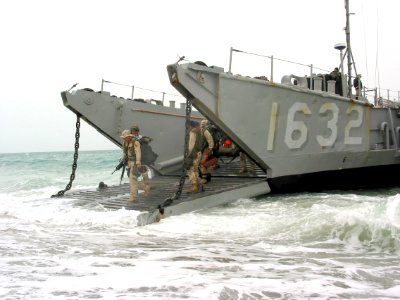US Navy 030322-N-1050K-010 Marines wade from a Landing Craft Utility vessel onto the dry land of Camp Patriot photo