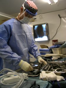 US Navy 030401-N-0728B-056 Hospital Corpsman 3rd Class Patrick Agan from Columbus, Ohio, prepares instruments for surgery just hours after the completion of construction of Fleet Hospital Three (FH-3)