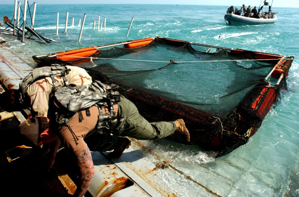 US Navy 030317-N-5319A-017 Members of the Deep-Shallow Water Mark 7 crew from Commander Task Unit (CTU-55.4.3) deploy a Miller Pen that will house a Bottle Nose Dolphin operating near the USS Gunston Hall (LSD 44)