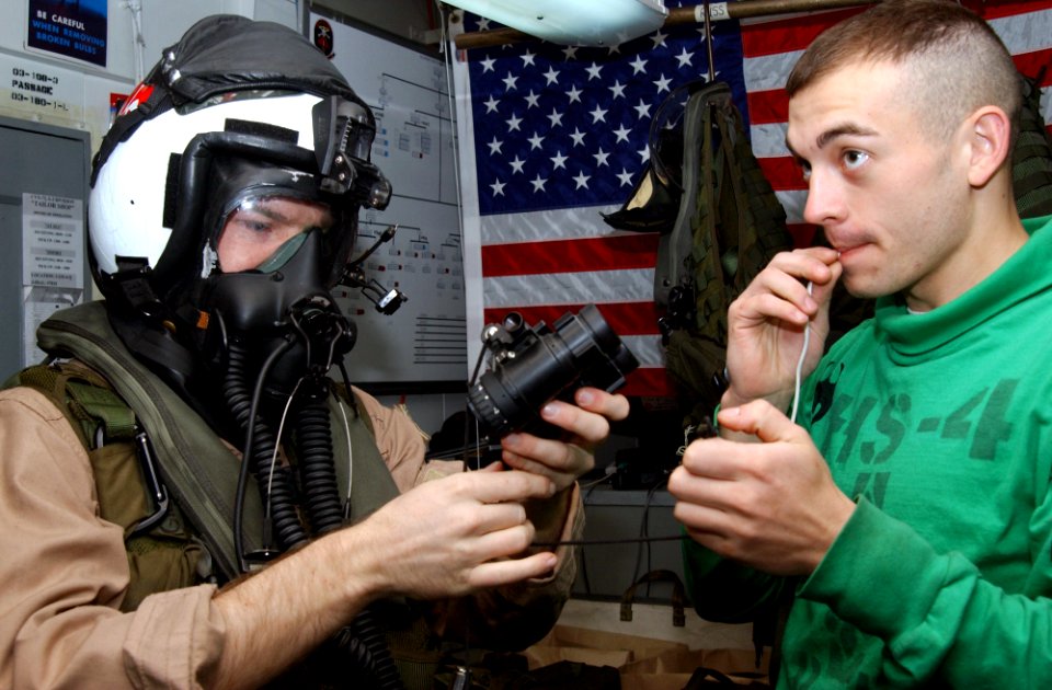 US Navy 030323-N-4336G-030 Aviation Anti-Submarine Warfare Operator 2nd Class Jarad Gilbertson from Cedar Ridges, Iowa. receives help from Survival Equipmentman 2nd Class Coale Lindsay from Cortez, Colo., with donning his chemi