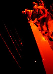 US Navy 030323-N-4048T-046 Deck Department personnel observe the night launch of a Rigid Hull Inflatable Boat (RHIB) aboard the amphibious assault ship USS Kearsarge (LHD 3