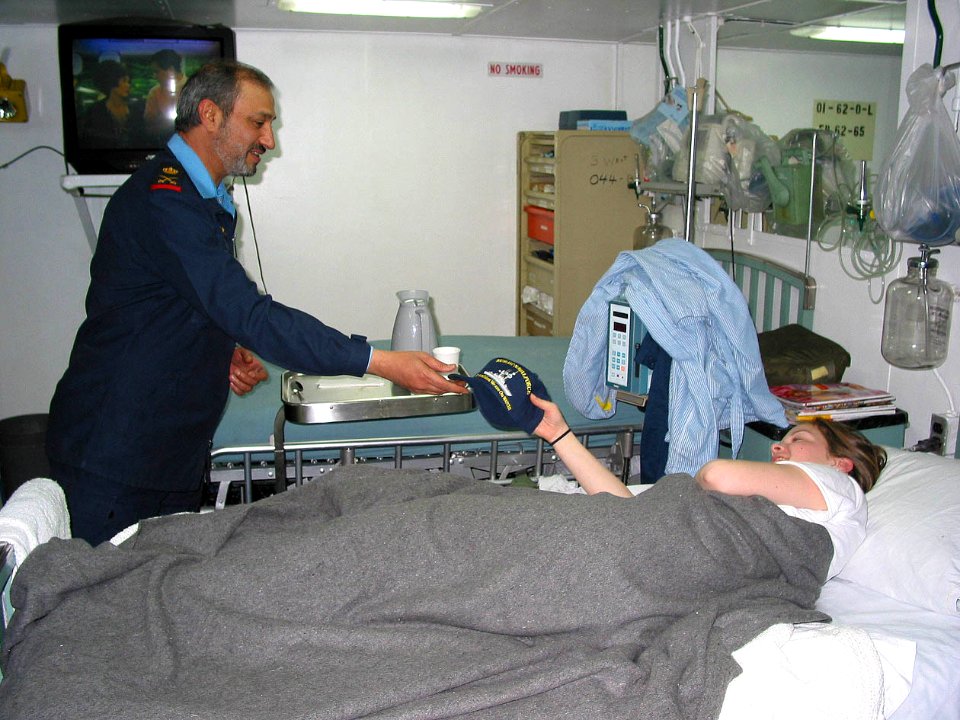 US Navy 030227-N-1050K-001 Kuwait's Commander of Naval Forces, Maj. Gen. Ahmad Al-Mulla, presents a ballcap to Seaman Jamie Hess. Maj. Gen. Al-Mulla, visited Tarawa's medical spaces as part of a tour of the San Diego-based amp
