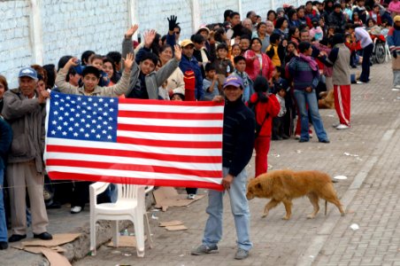 US Navy 070810-N-7088A-064 Peruvians display an American flag while waiting in line for medical care at Miguel Grau School in Salaverry