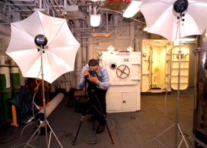 US Navy 030322-N-2819P-011 Photographer's Mate 3rd Class Angel Roman-Otero photographs crewmembers aboard USS Kearsarge (LHD 3) for the ship's cruise book
