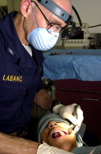 US Navy 030324-N-6536T-005 U.S. Navy Dentist Capt. John Labanc, from Hillsburrow, Ill., extracts a wisdom tooth