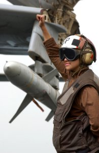US Navy 030327-N-1810F-014 Airman Rossana Ojeda signals ready aircraft for an EA-6B Prowler on the flight deck aboard the aircraft carrier USS Kitty Hawk (CV 63)