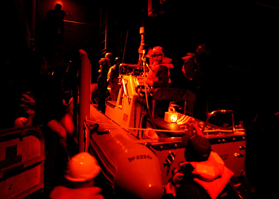 US Navy 030323-N-4048T-034 Deck Department personnel prepare for a night launch of a Rigid Hull Inflatable Boat (RHIB) aboard the amphibious assault ship USS Kearsarge (LHD 3)