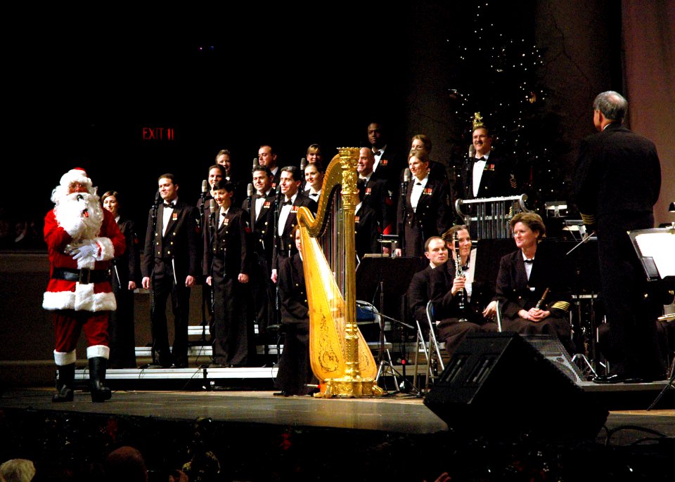 US Navy 061216-N-0773H-100 Santa Claus greets the Navy Band and its Director, Capt. Ralph M. Gambone during the 2006 Happy Holidays Concert