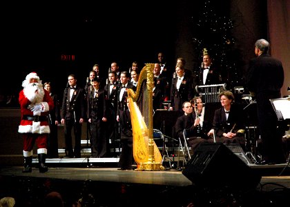 US Navy 061216-N-0773H-100 Santa Claus greets the Navy Band and its Director, Capt. Ralph M. Gambone during the 2006 Happy Holidays Concert photo