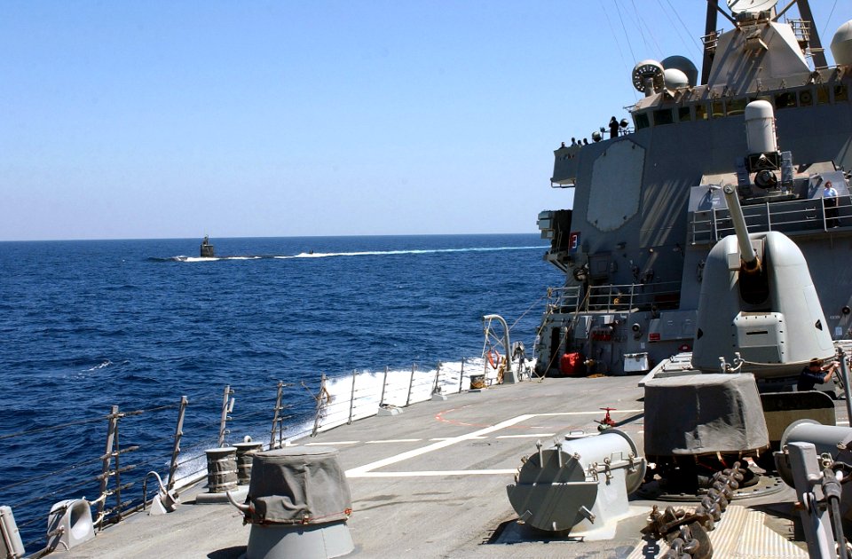 US Navy 030327-N-6141B-001 Attack submarine USS Toledo (SSN 769) conducts surface operations alongside the guided missile destroyer USS Donald Cook (DDG 75)