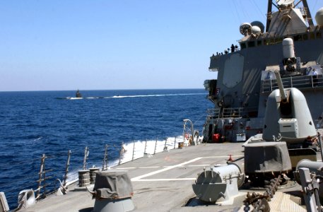 US Navy 030327-N-6141B-001 Attack submarine USS Toledo (SSN 769) conducts surface operations alongside the guided missile destroyer USS Donald Cook (DDG 75)