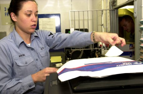 US Navy 030325-N-6536T-003 Postal Clerk 3rd Class Rhiannon Krone from San Clemente, Calif., places the proper postage on a piece of outgoing mail aboard USS Nimitz (CVN 68)