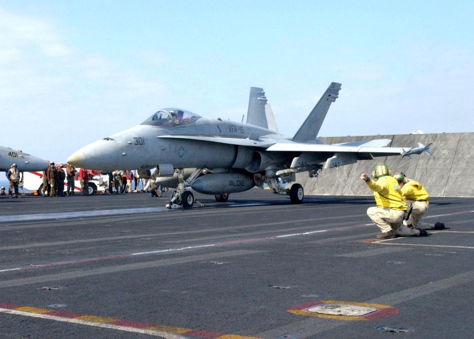 US Navy 030314-N-6895M-512 shooters give the signal for launch to an F-A-18 Hornet