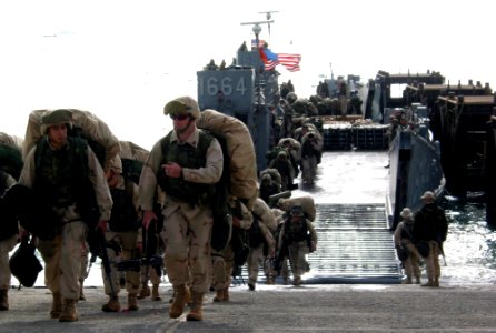 US Navy 030329-N-1050K-034 Elements of the 24th Marine Expeditionary Unit (MEU), offload personnel and equipment at Camp Patriot