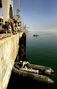 US Navy 030328-N-3783H-360 Members of Commander Task Unit (CTU-55.4.3) prepare to launch a ridgid hull inflatable boat (RHIB) to perform a final check of the port facility for Iraqi mines