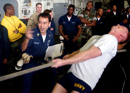 US Navy 030329-N-1512S-037 Hospital Corpsman 1st Class Dan Salazar from Orlando, Fla., cheers on Senior Chief Hospital Corpsman Glenn Baxter during a Tug-of-War contest
