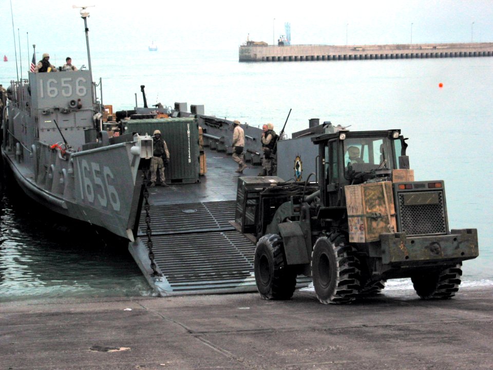 US Navy 030330-N-1050K-004 U.S. Army personnel assigned to the 567th Transportation Company offload water and general military supplies from a U.S. Navy landing craft utility (LCU)