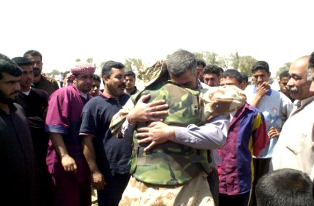 US Navy 030328-A-2018L-008 A member of the Free Iraqi Forces (FIF) is reunited with family members in his home village. Free Iraqi Forces are Shiia and Sunni Muslims, Arabs and Kurds, all exiled from Iraq who are committed to photo
