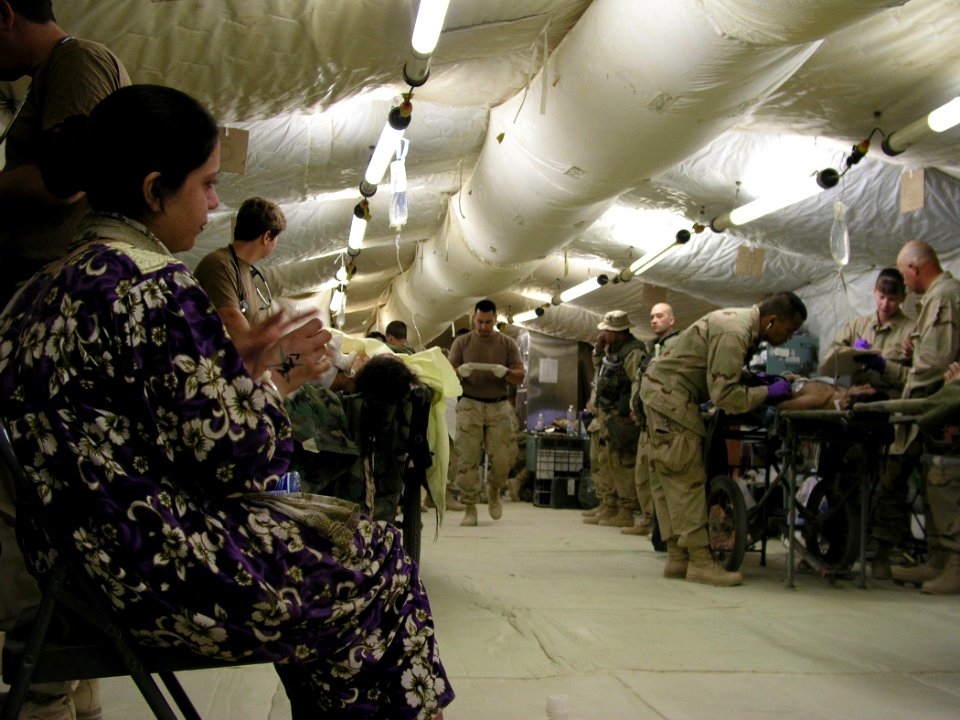 US Navy 030414-N-0728B-004 An unidentified Iraqi woman (foreground) who arrived in Fleet Hospital Three's (FH-3) Casualty Receiving room with an ankle injury