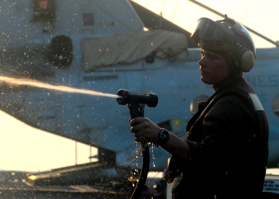 US Navy 080723-N-5148B-003 Cpl. Mathew Roberts gives a helicopter a fresh-water wash down