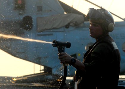 US Navy 080723-N-5148B-003 Cpl. Mathew Roberts gives a helicopter a fresh-water wash down