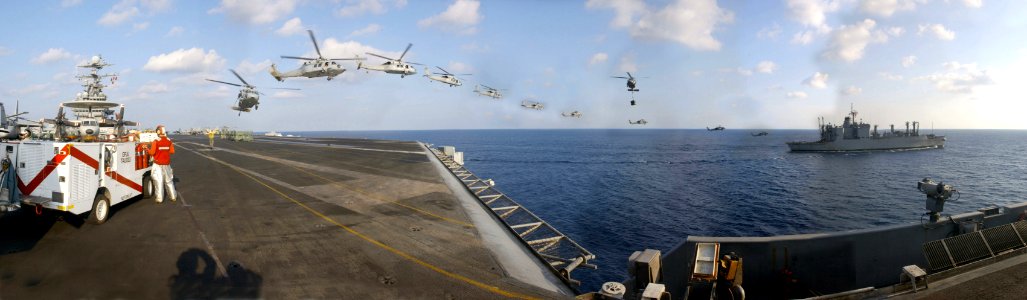 US Navy 030329-N-9964S-001 This panoramic view consists of the Military Sealift Command ammunitions ship USNS Mt. Baker (T-AE 34) as it pulls alongside USS Harry S. Truman (CVN 75) photo