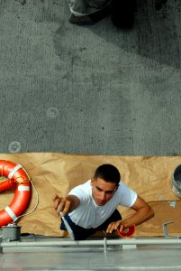US Navy 080805-N-4995K-341 Boatswain's Mate Seaman Armen Bakanyan paints a pipe