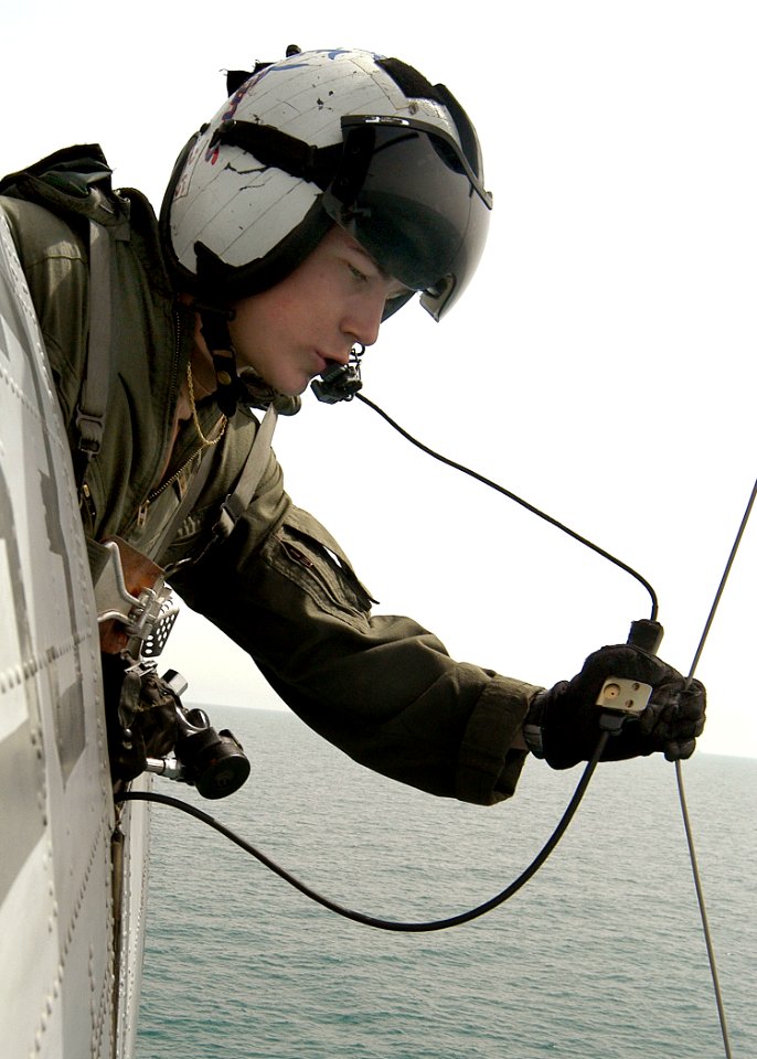 US Navy 030330-N-2819P-026 Aviation Machinist's Mate 2nd Class Joseph Harris retrieves the horse collar