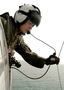 US Navy 030330-N-2819P-026 Aviation Machinist's Mate 2nd Class Joseph Harris retrieves the horse collar