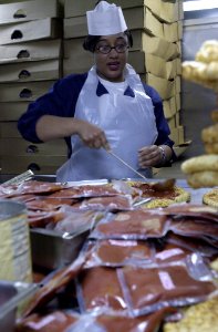 US Navy 030419-N-2143T-011 Aviation Ordnanceman 1st Class Lisa Mack prepares pizza for the crew of USS Nimitz (CVN 68), and Carrier Air Wing 11 (CVW-11) as part of the First Class Pizza Night