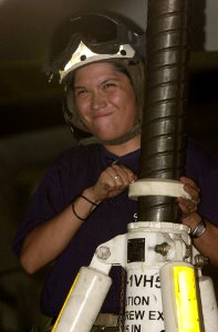 US Navy 030413-N-9319H-002 Aviation Maintenance Administrationman Cathy Garcia participates in the elevating of an E-2C Hawkeye