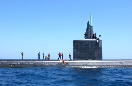 US Navy 030327-N-6141B-008 Personnel from the attack submarine USS Toledo (SSN 769) stand by to receive supplies from the guided missile destroyer USS Donald Cook (DDG 75)