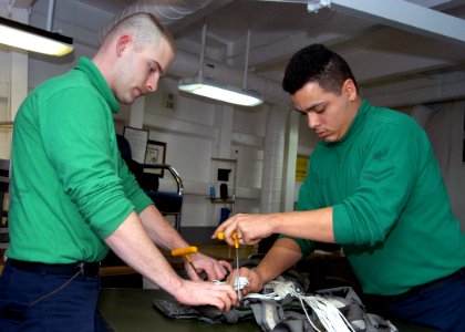 US Navy 030402-N-5786V-508 Aircrew Survival Equipmentman Airman Jeremiah Cranford and Aircrew Survival Equipmentman 2nd Class James Hess assigned to USS Theodore Roosevelt's (CVN 71) Aviation Intermediate Maintenance Department