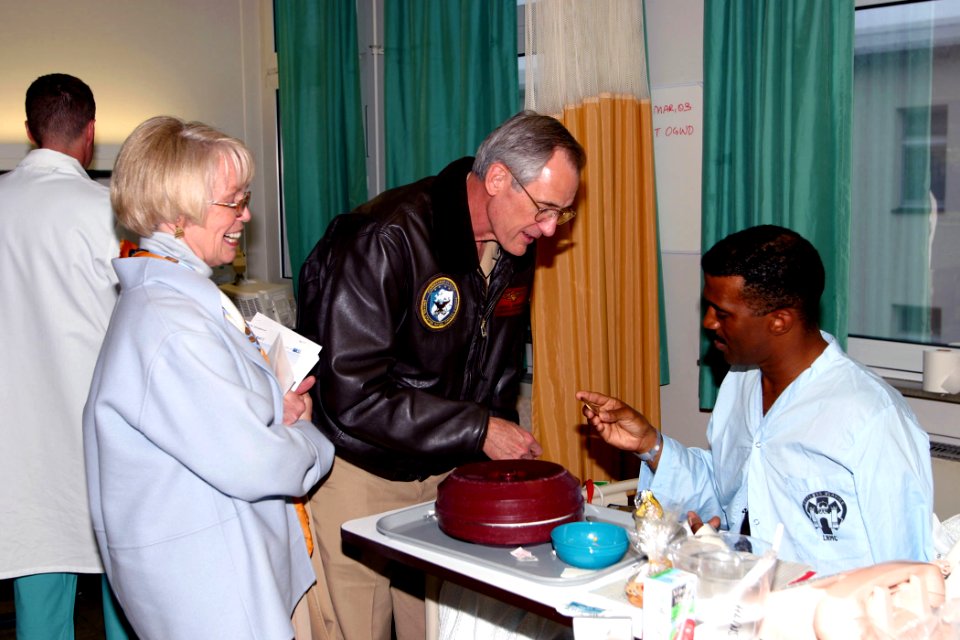US Navy 030403-D-0000B-003 Commander, U.S. Naval Forces Europe, Adm. Gregory Johnson and his wife present U.S. Air Force Technical Sgt. Isaac Smith with a 'Commander's Coin'
