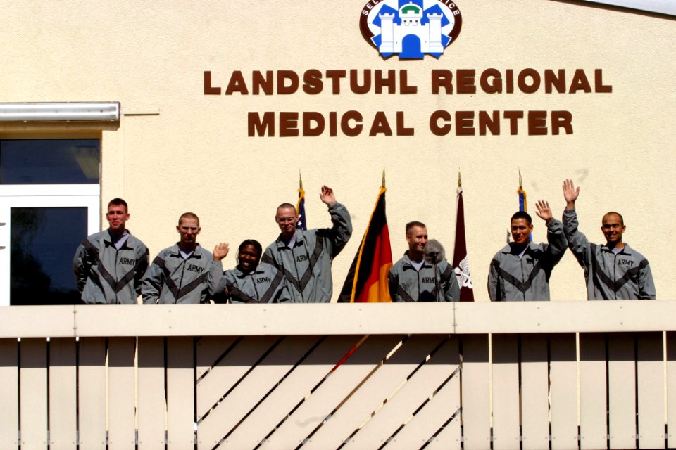 US Navy 030418-D-7433T-001 Seven Army former POW's greet the media form the balcony of their hospital ward at Landstuhl Regional Medical Center