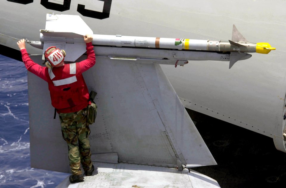 US Navy 030403-N-9319H-012 An Aviation Ordnancman perform a weapons inspection on an AIM-9 Sidewinder air-to-air missile mounted on an F-A-18F Super Hornet assigned to the Black Aces of Strike fighter Squadron F