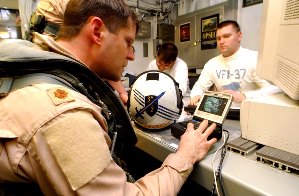 US Navy 030320-N-3235P-518 Minutes after landing his fighter aircraft aboard USS Harry S. Truman (CVN-75), an aircrewman reviews footage taken from the aircraft's Low Altitude Navigation and Targeting Infrared for Night (LANTIR